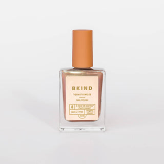 A bottle of BKIND Vegan & 21-free Nail Polish in color pearly rose gold, with a capacity of 15 ml.