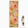 Eco-friendly cork yoga mat displayed rolled and laid flat, showing the Botanicals design and natural cork surface